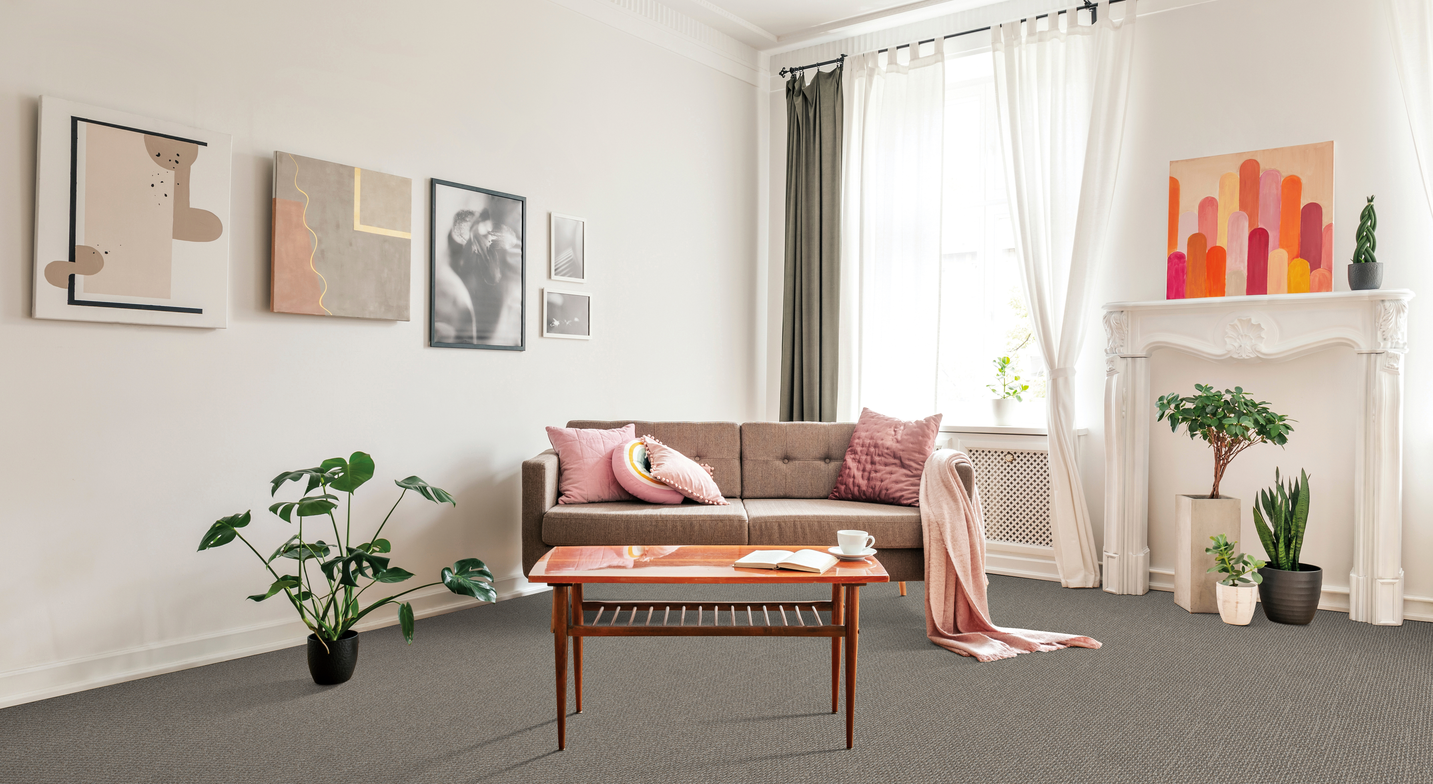 Gibraltar gray carpet in living space featuring small coffee table, couch, plants and artwork by window